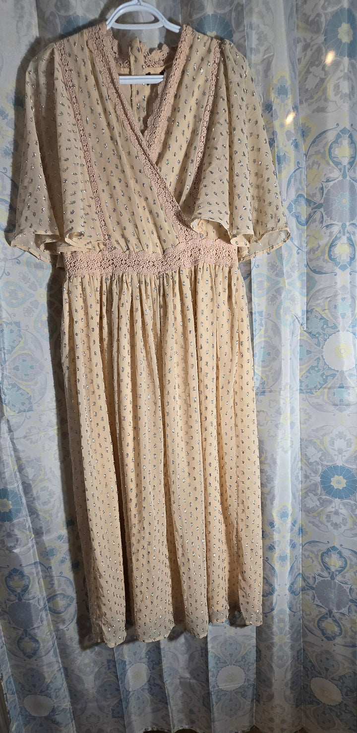 a dress hanging on a curtain in a room