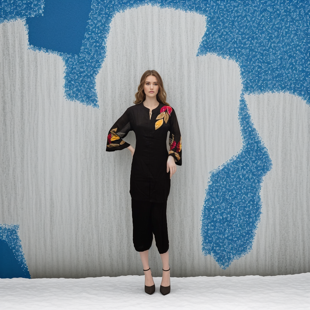 a woman standing in front of a blue and white wall